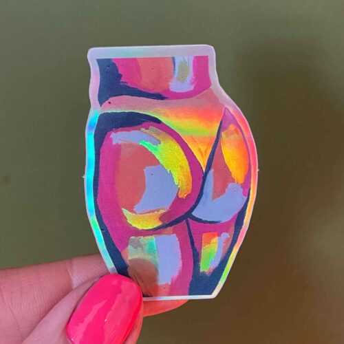 holographic butt sticker on green background