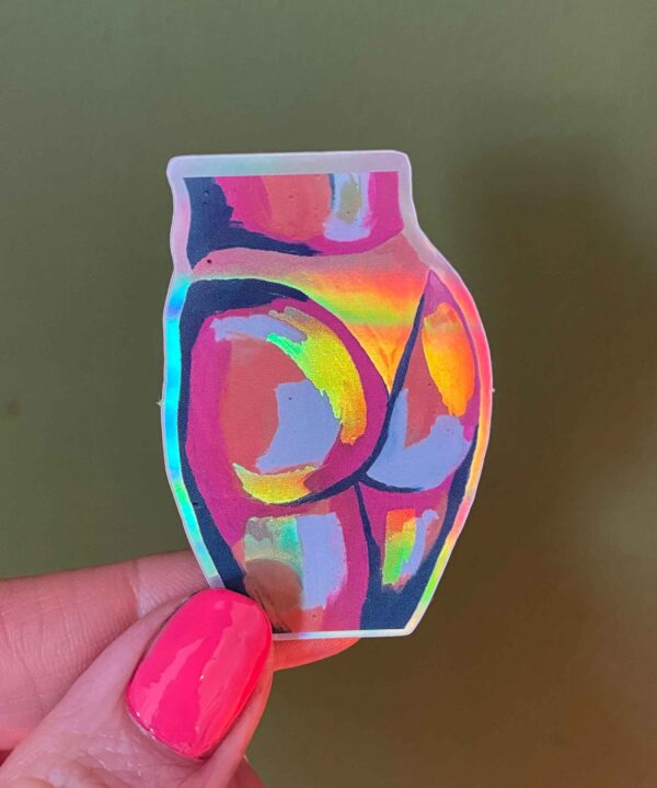 holographic butt sticker on green background