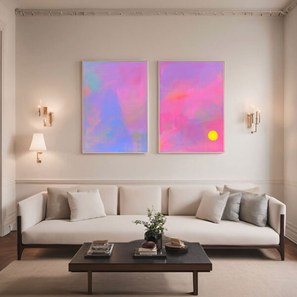 Pink purple and blue abstract art paintings above a neutral sofa with wall lights either side