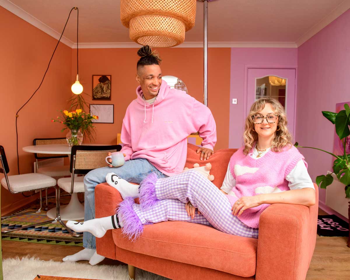 Georgie and Kern sat in their pink and peach living room