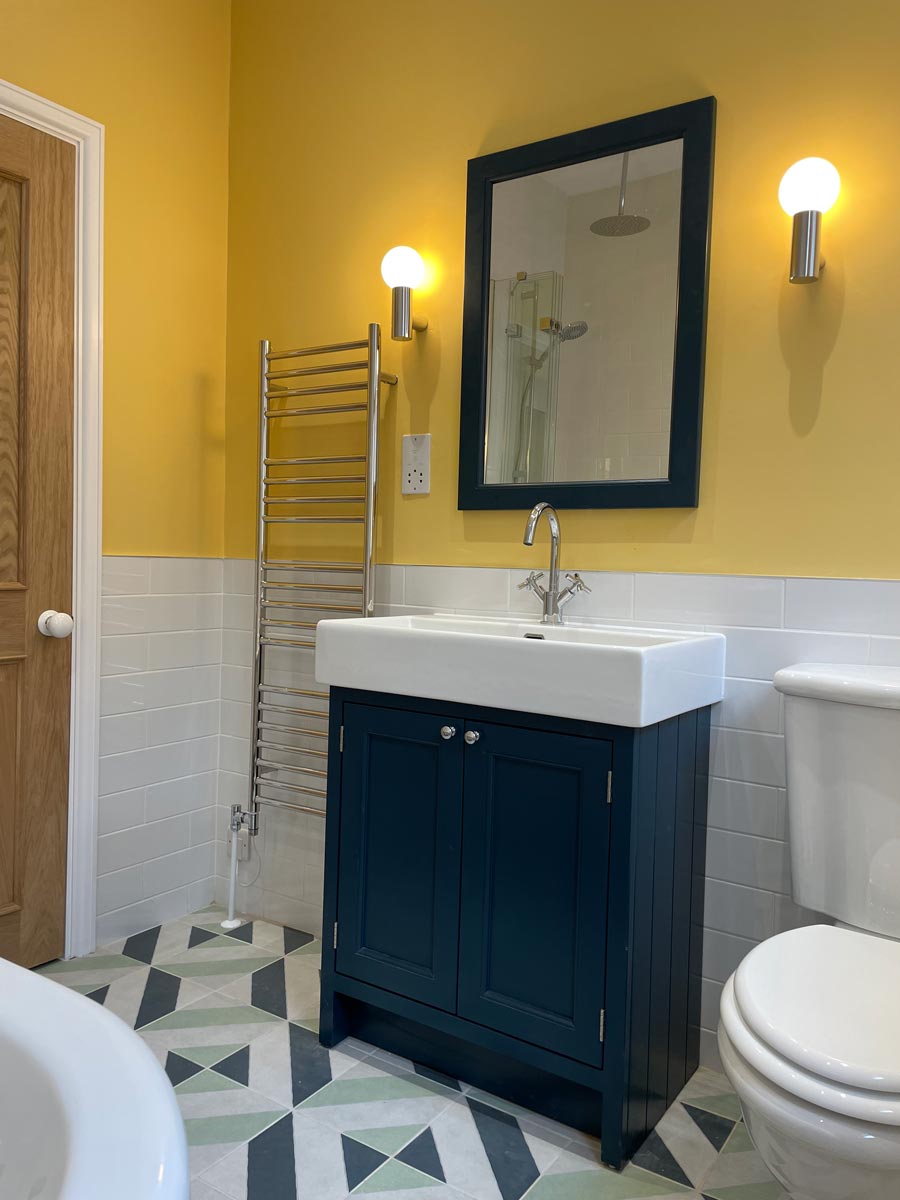 Yellow-bathroom-with-navy-and-green-tiles-Georgie-Web-Art-and-Interiors-Bristol