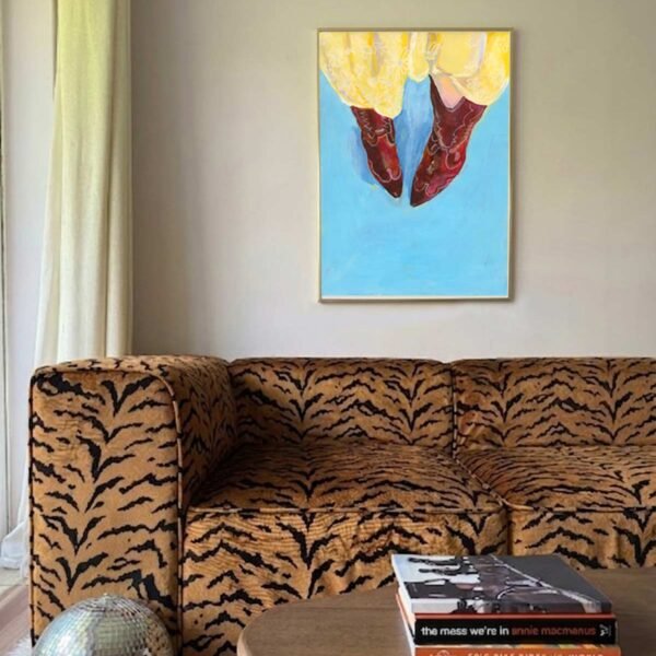cowboy boots on blue background and yellow skirt above a tiger print sofa