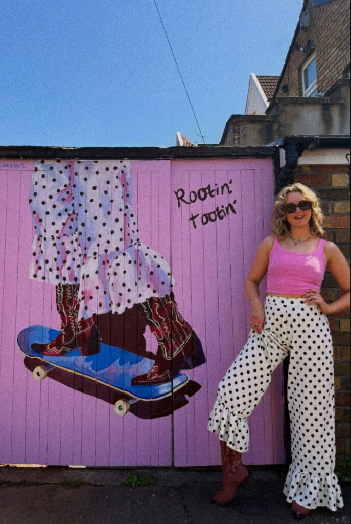 Georgie and skateboarding cowgirl mural